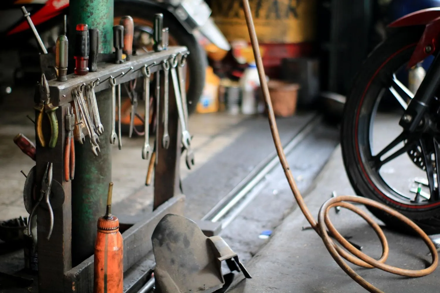 Workshop tool rack hung with wrenches, pliers and screwdrivers